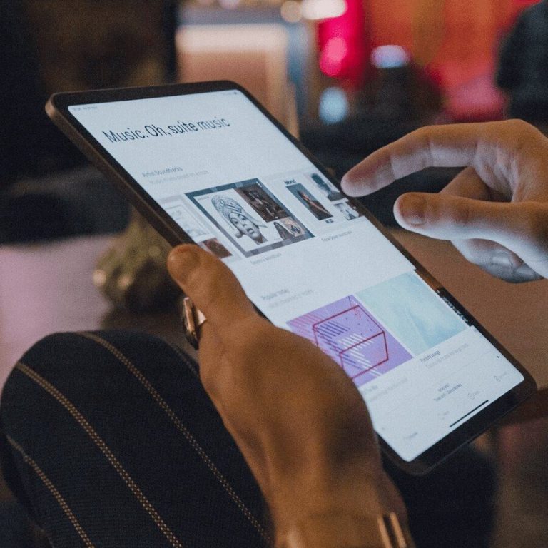 person managing soundtrack your brand on iPad