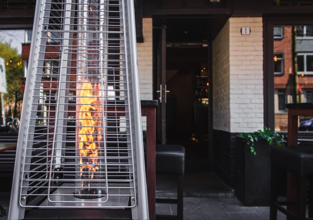 A free-standing heater is shown at the entrance of a restaurant.