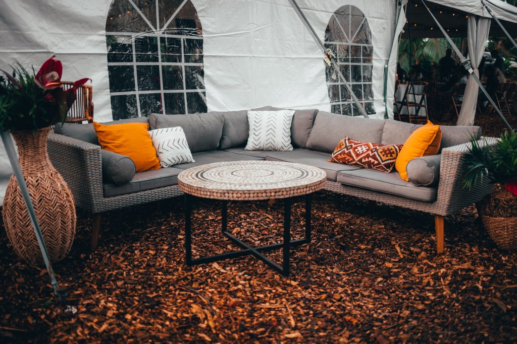 Outdoor patio furniture is shown with yellow accent pillows, matching the vibe of the approaching fall season.