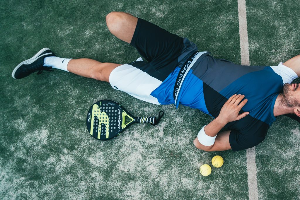 A tennis player rests after a long match.