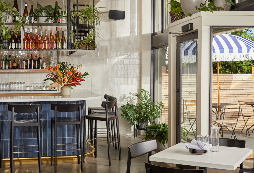 restaurant with sonos five speaker mounted on the wall near the entrance