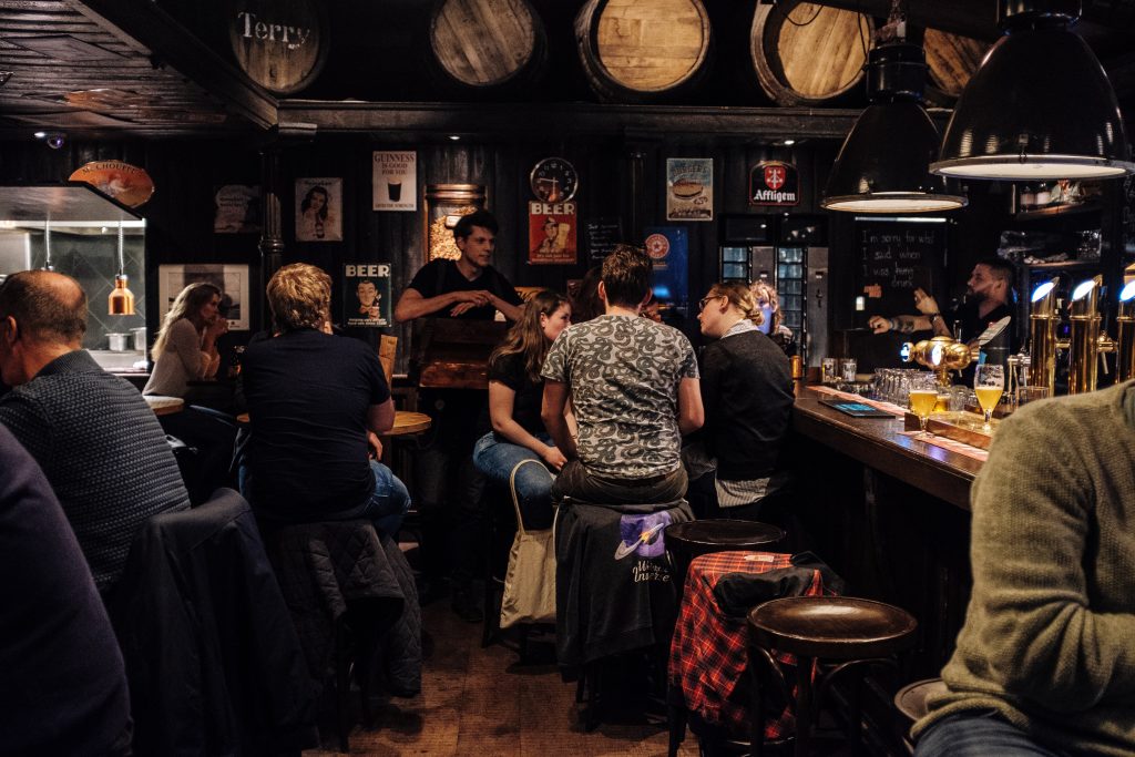A dimly lit pub is filled with music lovers